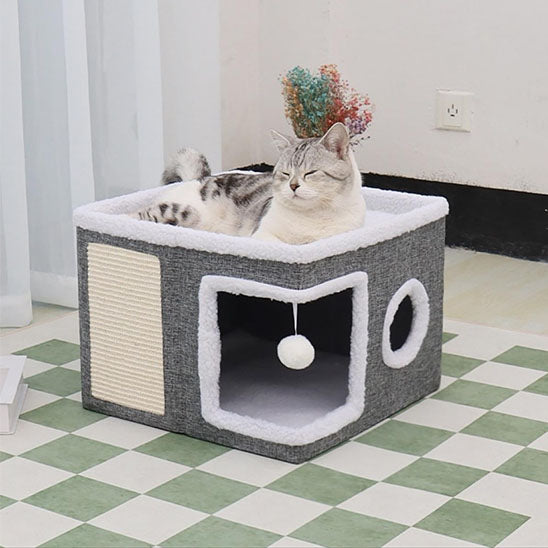 maison pour chat carré de couleur gris et blanc avec un toit avec un chat coucher dessus et un griffoir pour les griffes