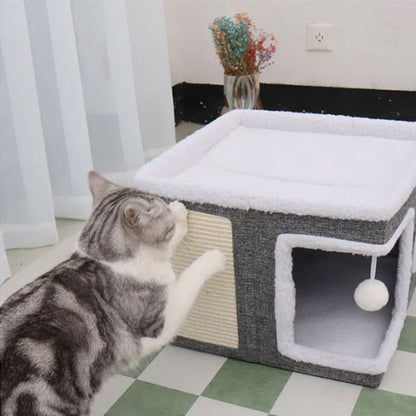 maison pour chat de couleur gris et blanc assez grand pour deux chat et on voit un chat faire ses griffe sur le petit griffoir qui est dessus sur le côté